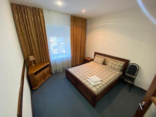 a small bedroom with a bed and a window at White New Apartments Ultracentral 2-rooms in the Heart Chisinau in Chişinău