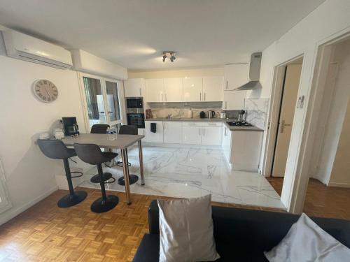 une cuisine et un salon avec une table et des chaises dans l'établissement Superbe T4 spacieux tout équipé,, à Marseille