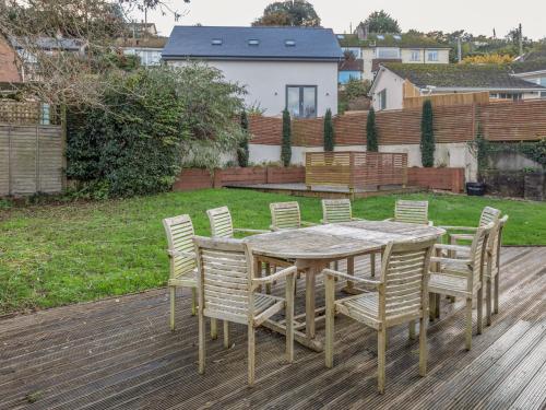 a wooden table and chairs on a deck at Welsummer in Salcombe