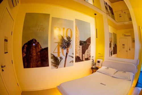 a hospital room with a bed and pictures on the wall at Motel Itapuã III Fx Rosário do Sul in Santa Maria