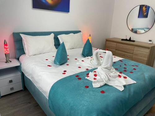 a bedroom with a bed with hearts on it at Apartamente Lux SYA Residence in Braşov