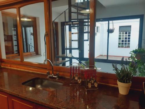 a bathroom with a sink and a mirror and a staircase at Cálido y confortable Chalet a metros Mendoza Plaza Shopping in Guaymallen