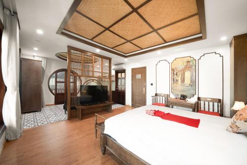 um quarto com uma cama grande e uma televisão de ecrã plano em Veshia Hotel & Spa em Hanói