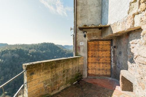 a building with a wooden door on the side of it at Opera Suites - Le notti bianche in Calcata