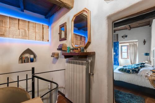 a bedroom with a bed and a door with a window at Opera Suites - Le notti bianche in Calcata