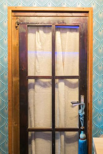 a door with a window with a vase in front of it at Opera Suites - Le notti bianche in Calcata