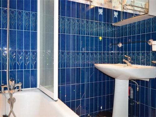 a blue tiled bathroom with a sink and a tub at Appartement Font-Romeu-Odeillo-Via, 3 pièces, 6 personnes - FR-1-580-32 in Font-Romeu-Odeillo-Via
