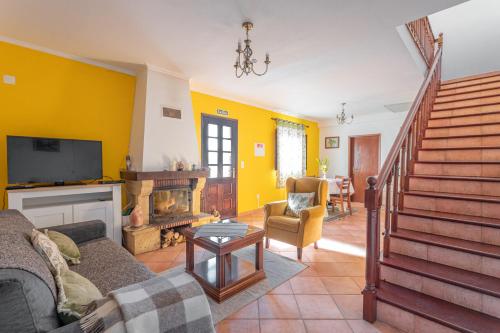 a living room with a couch and a fireplace at Cantinho Rural in Camacha