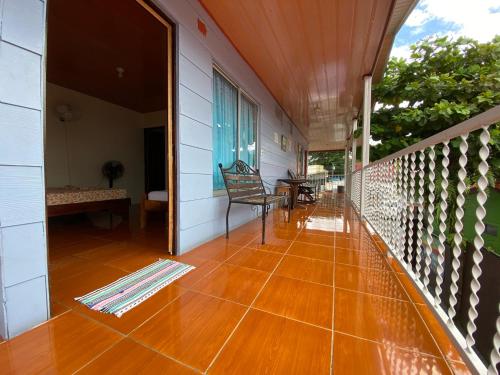 a porch of a house with a wooden floor at Cabinas Las Palmas del Sol in Fortuna