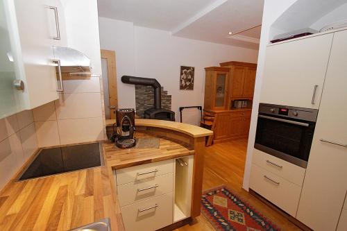 a kitchen with white cabinets and a counter top at Gästehaus Steinerhof in Nikolsdorf