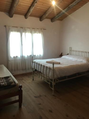a bedroom with two beds and a window at La Haciendita Hostel in Humahuaca