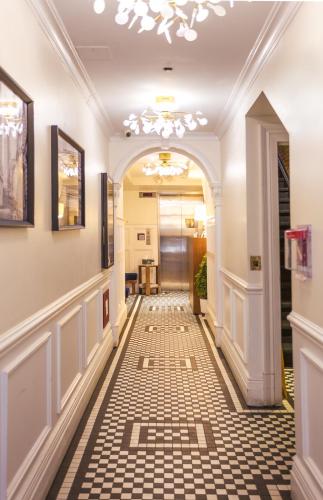 a hallway with a tile floor and a chandelier at Hotel Scherman in New York