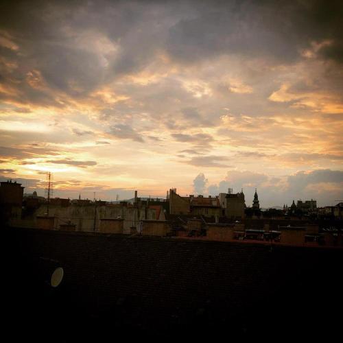 a view of a city with a cloudy sky at Erkel Rooftop Suites in Budapest