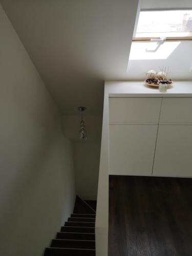 a staircase in a room with a skylight at Erkel Rooftop Suites in Budapest