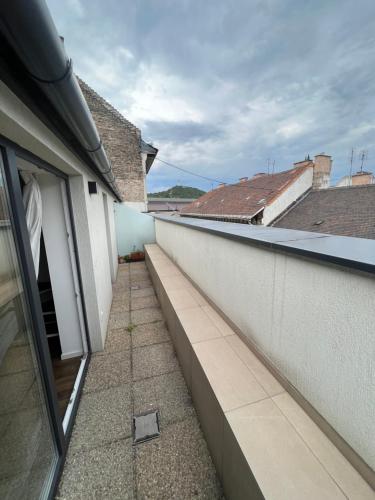 an empty balcony of a building with a window at Erkel Rooftop Suites in Budapest