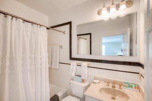 a white bathroom with a toilet and a sink at Elaine's Cape May Boutique Hotel in Cape May