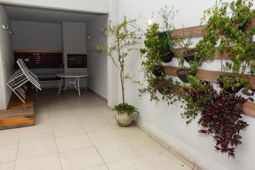 einen Korridor mit Topfpflanzen an einer Wand in der Unterkunft 360 Av Ipiranga in São Paulo