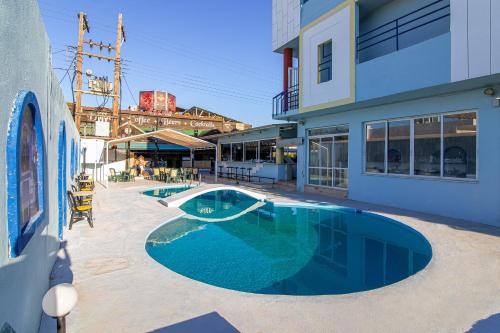 a swimming pool in front of a building at Minoa Hotel in Malia