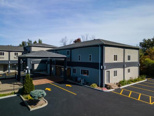 a parking lot in front of a building at Days Inn & Suites by Wyndham Niagara Falls/Buffalo in Niagara Falls