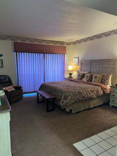 a bedroom with a large bed and a chair at River Place Condos #110 3BD in Pigeon Forge
