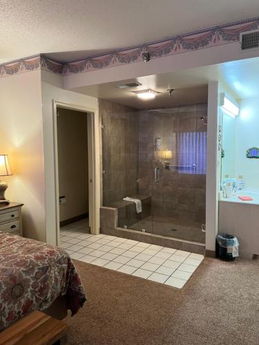 a bedroom with a shower and a bed and a tub at River Place Condos #110 3BD in Pigeon Forge