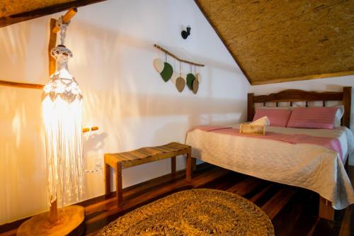 a bedroom with a bed and a lamp in a room at Casa Mangue in Macapá