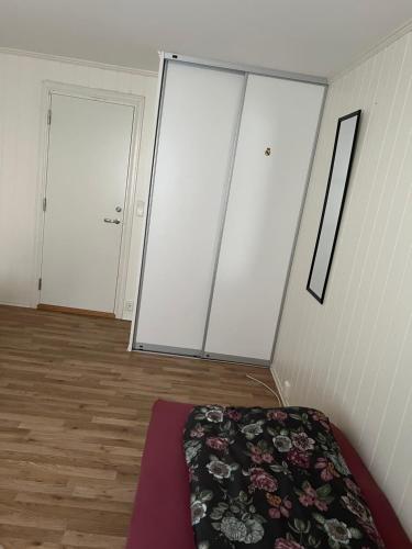 a room with two large sliding doors and a bed at Bedroom in city centre, no shower available in Ålesund