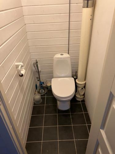a small bathroom with a toilet in a stall at Bedroom in city centre, no shower available in Ålesund