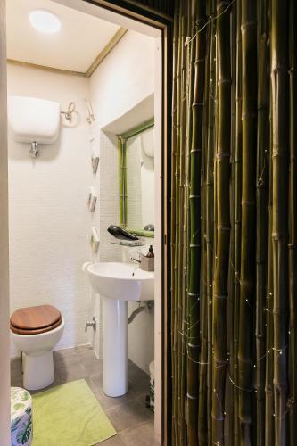 a bathroom with a toilet and a sink at Opera Suites - Il sentiero della felicità in Calcata