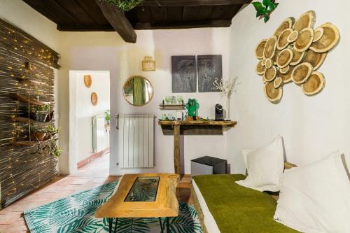 a living room with a couch and a table at Opera Suites - Il sentiero della felicità in Calcata