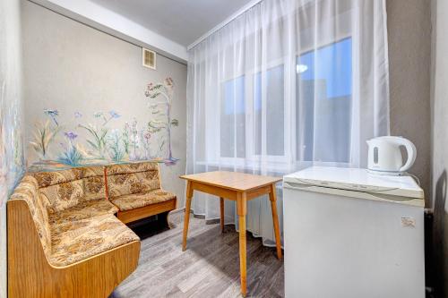 a living room with a couch and a table at Holosiyvsky Hotel in Kyiv