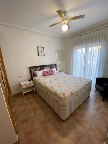 a bedroom with a bed and a ceiling fan at Villa Arizona in Catral