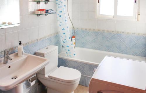 a bathroom with a white toilet and a sink at Cozy Apartment In Los Alcazares With Wifi in Los Alcázares