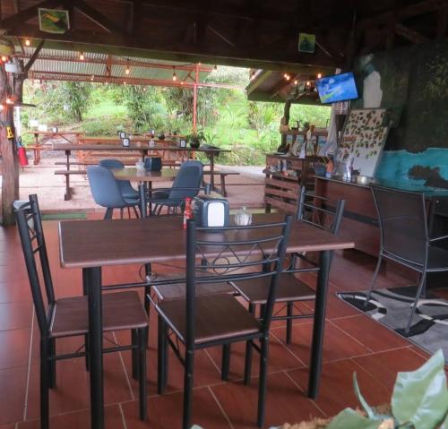 San RafaelにあるGarza del Sol Glamping Río Celeste Bromeliaのレストランのテーブルと椅子
