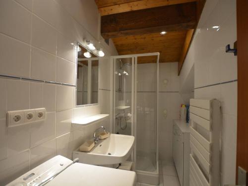a bathroom with a sink and a shower and a toilet at Appartement Le Grand-Bornand, 4 pièces, 7 personnes - FR-1-241-218 in Le Grand-Bornand