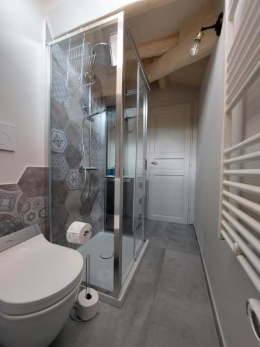a bathroom with a toilet and a glass shower at Circo Massimo Apartment & Terrace in Rome
