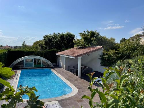 einen Pool in einem Hof mit einem Haus in der Unterkunft Très belle villa avec piscine dans la Drôme in Romans-sur-Isère