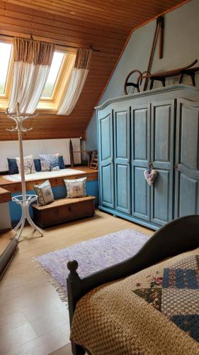 a living room with a blue cabinet and a couch at Chalupa Kamenná Horka in Krásná Lípa