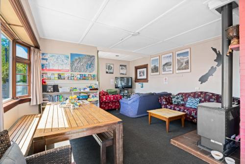 a living room with a couch and a table at Mountain View Backpackers in Wanaka