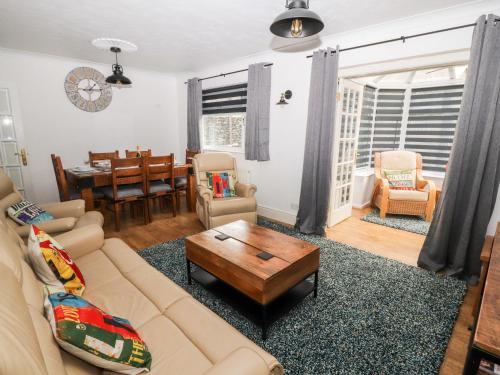 a living room with a couch and a table at Mylnebeck Lodge in Windermere