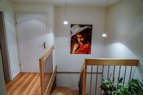 a staircase with a painting hanging on a wall at Zug Business Room Breathtaking View in Zug