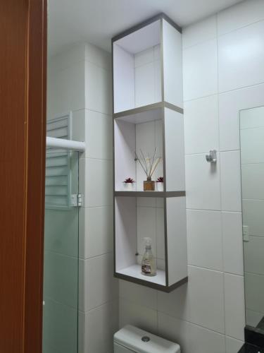 a bathroom with a toilet and a glass shower at Studio Frente para o Mar - Matinhos in Matinhos