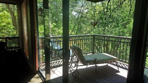 a chair sitting on a porch with a window at Inn Above Oak Creek Sedona in Sedona