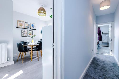 a dining room and kitchen with a table and chairs at Westwood Lodge Serviced Apartment in Coventry