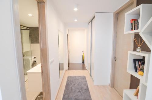 a hallway with white walls and a hallway with a rug at Luna Deluxe Apartment & Free Parking in Sarajevo