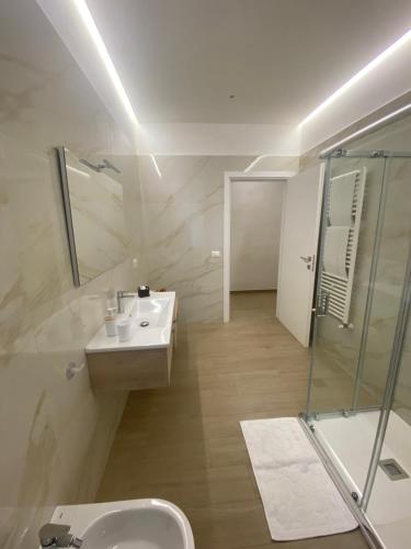 a bathroom with a sink and a shower at Cà Sal Holiday Home in Lesina