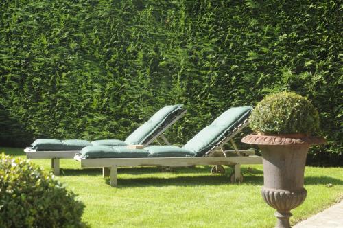 a couple of lounge chairs sitting in the grass at Hotel Astoria Gent in Ghent