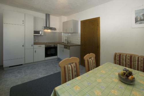 a kitchen with a table with a bowl of fruit on it at Haus Deiser in Kappl
