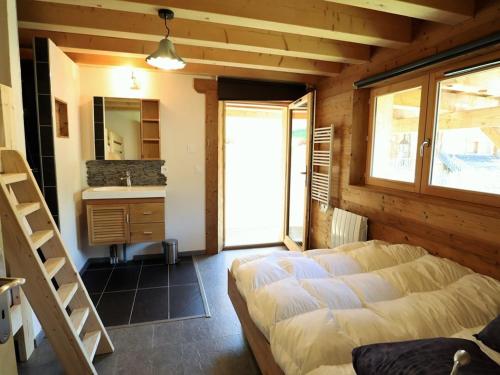 a bedroom with a bed and a sink in a room at Chalet Arêches-Beaufort, 4 pièces, 8 personnes - FR-1-342-208 in Beaufort