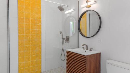 a bathroom with a sink and a mirror at Limon Palm Springs A Luxury Boutique Hotel in Palm Springs